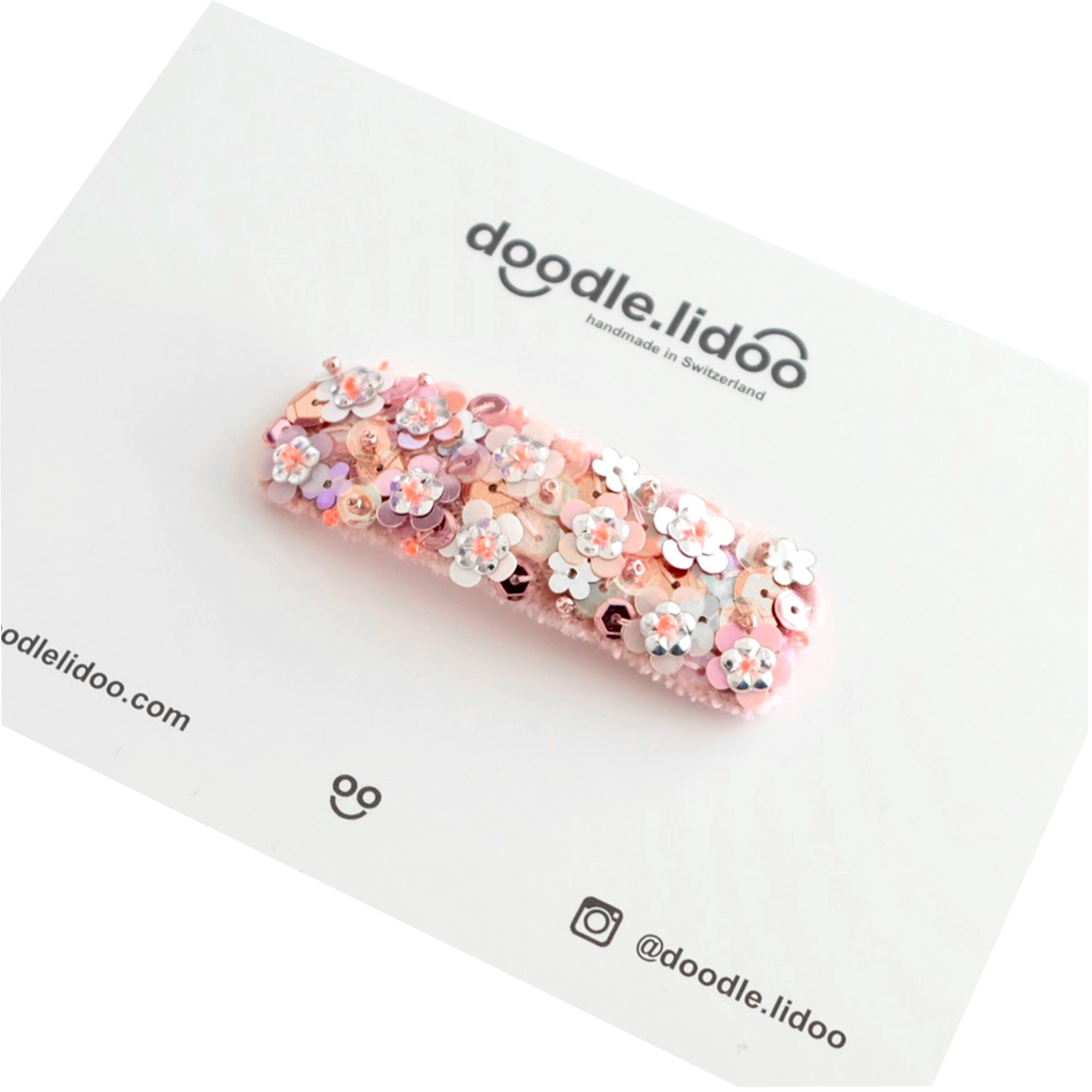 An oversized hair clip made with silk velvet and embellished with sequins.