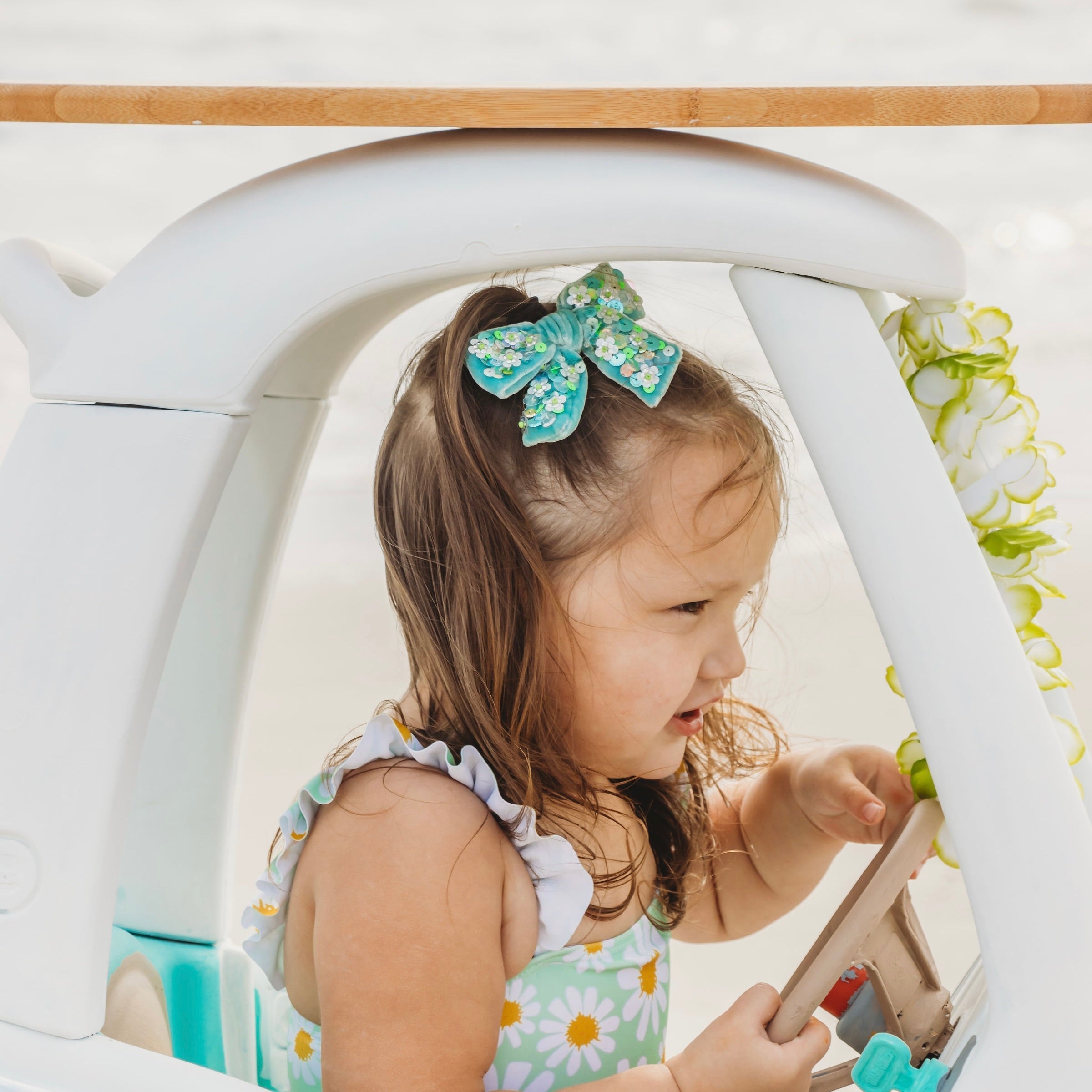 Ivy hair bow sparkly sequins in size medium worn by a toddler girl.