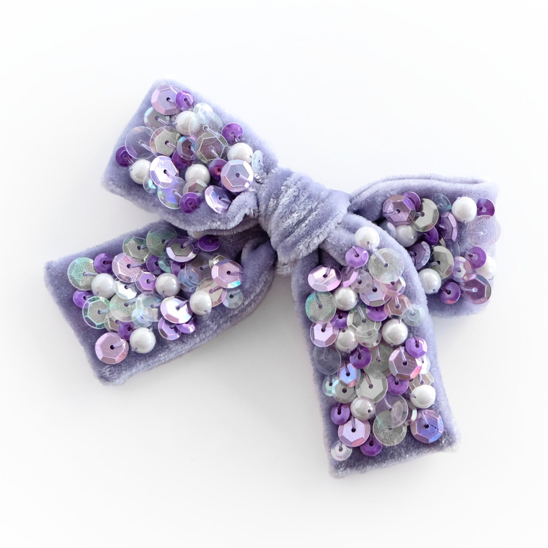 lavender color velvet hair bow with sequins and pearls.