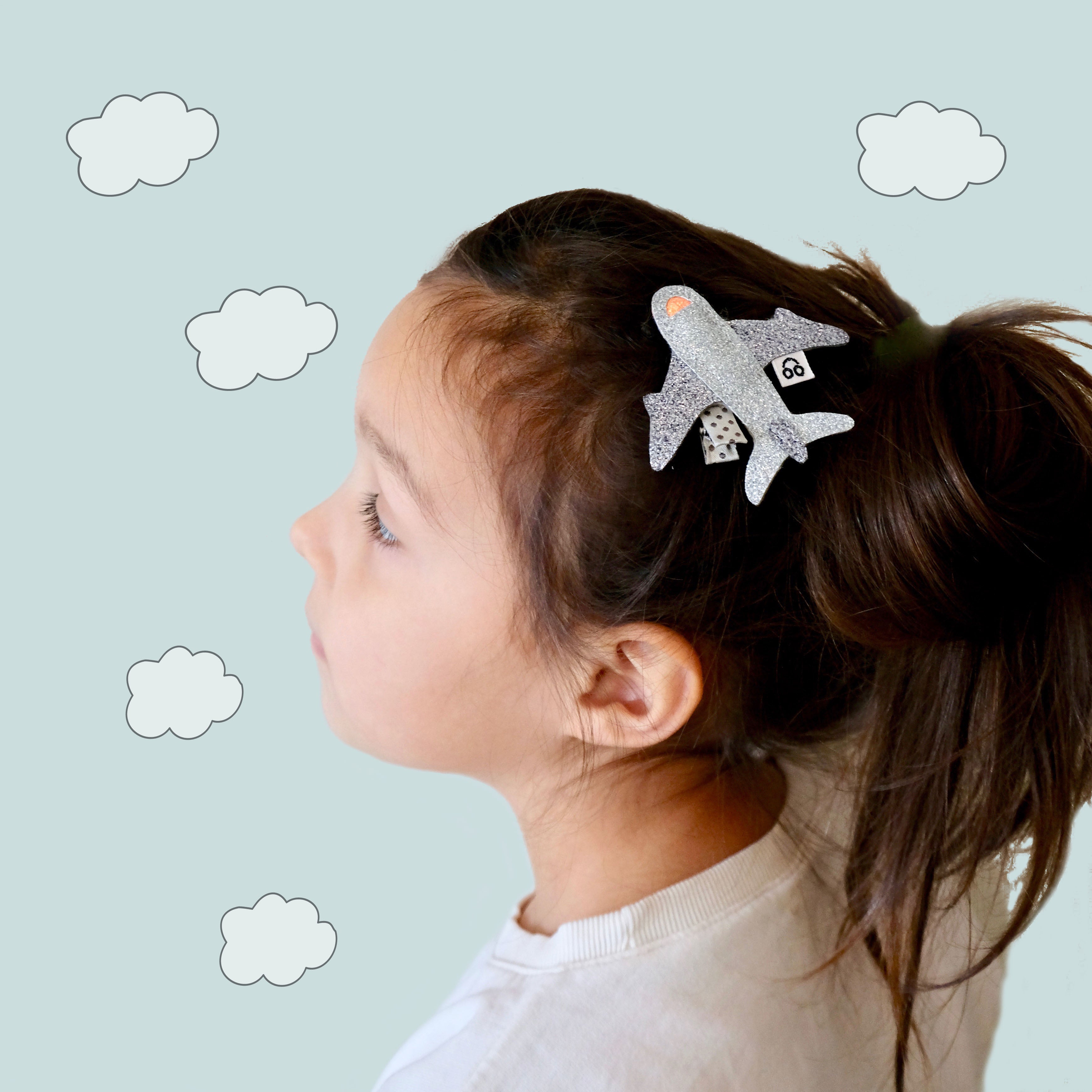 A silver hair clip in the shape of a fun airplane.  This is a fun hair accessory and a great gift for a first time traveller.