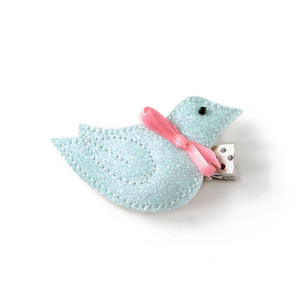 Sweet little light blue hair clip in the form of a small bird, wearing a pink bow.