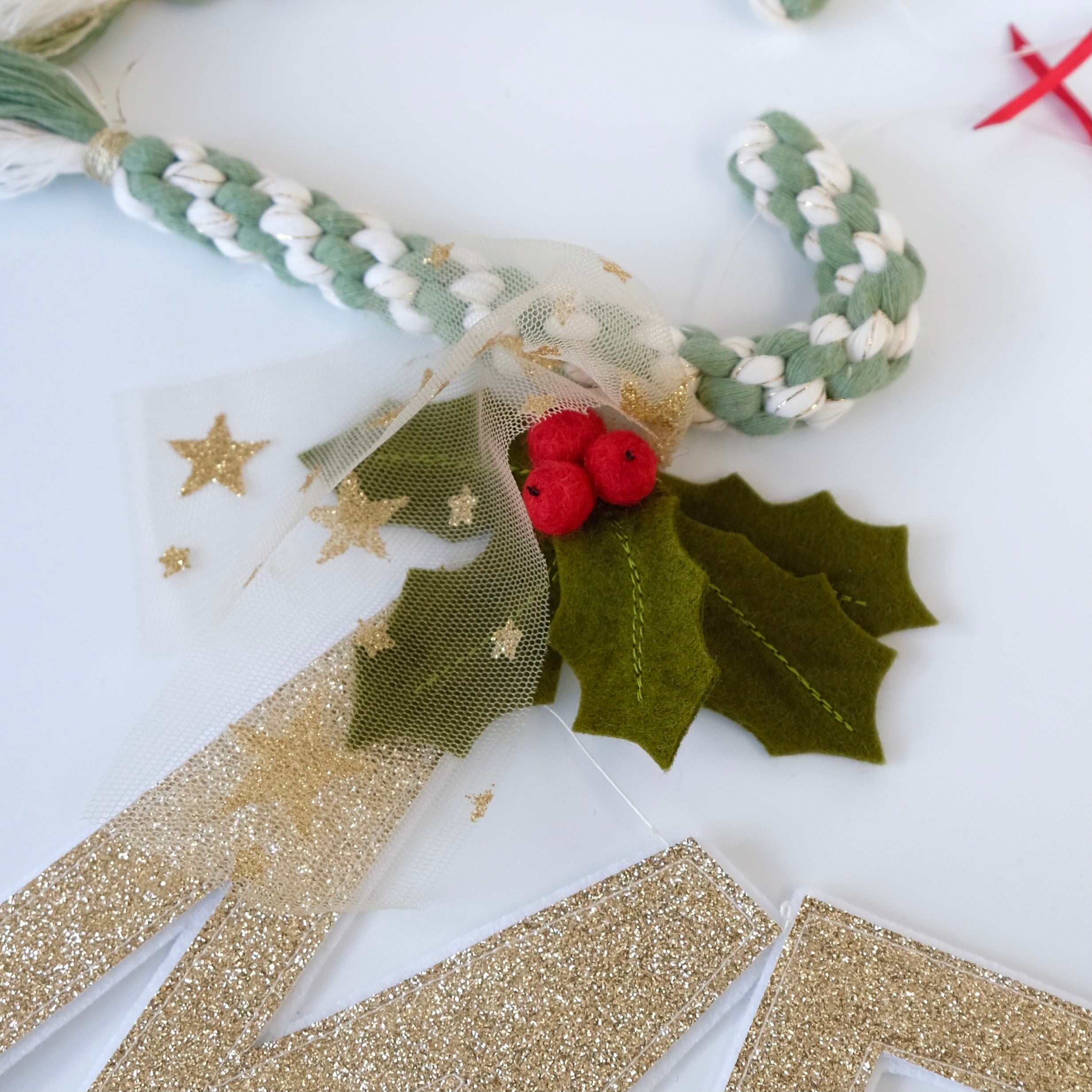 Holly detail on Christmas garland.