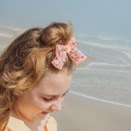 Avalon hair bow made from peach silk velvet and embellished with sparkly sequins.