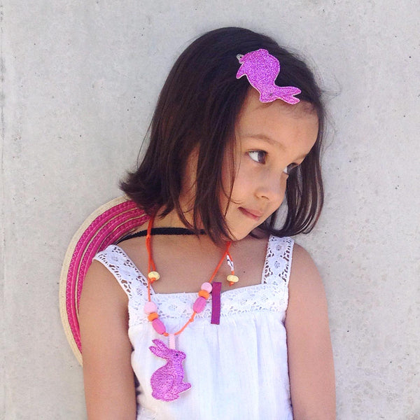 Little girl with an adorable bunny hair clip and matching necklace.