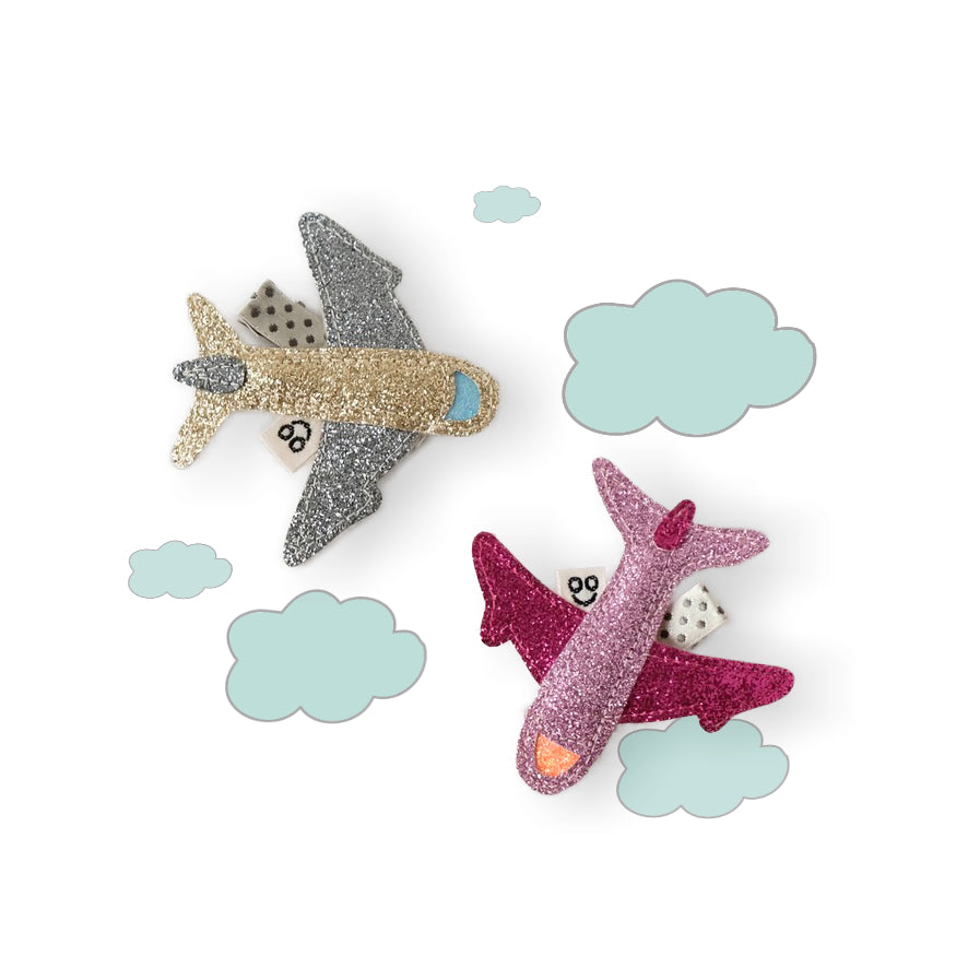 Airplane hair clips made from sparkly fabric and available in vibrant colors.