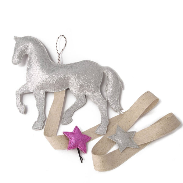 A modern hair bow organizer in the shape of a pony.  This is a excellent gift for a little equestrian.