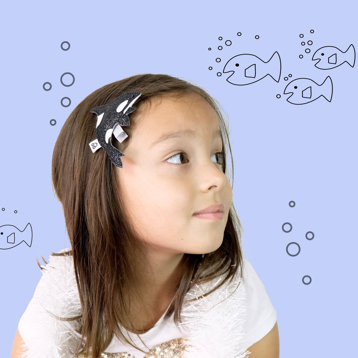Toddler girl wearing our fun and oversized Orca the killer whale hair clip. 