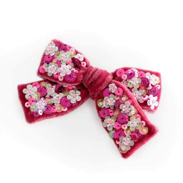 Our Ruby silk velvet hair clip embellished with an array of pink and silver sequins.