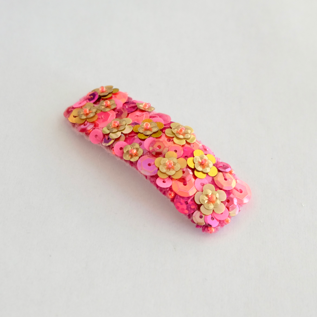 Our Sienna hair clip, large and gorgeously embellished with gold, pink and orange sequins.