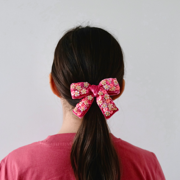 Our silk velvet hair bow with sequin worn on a pony tail.