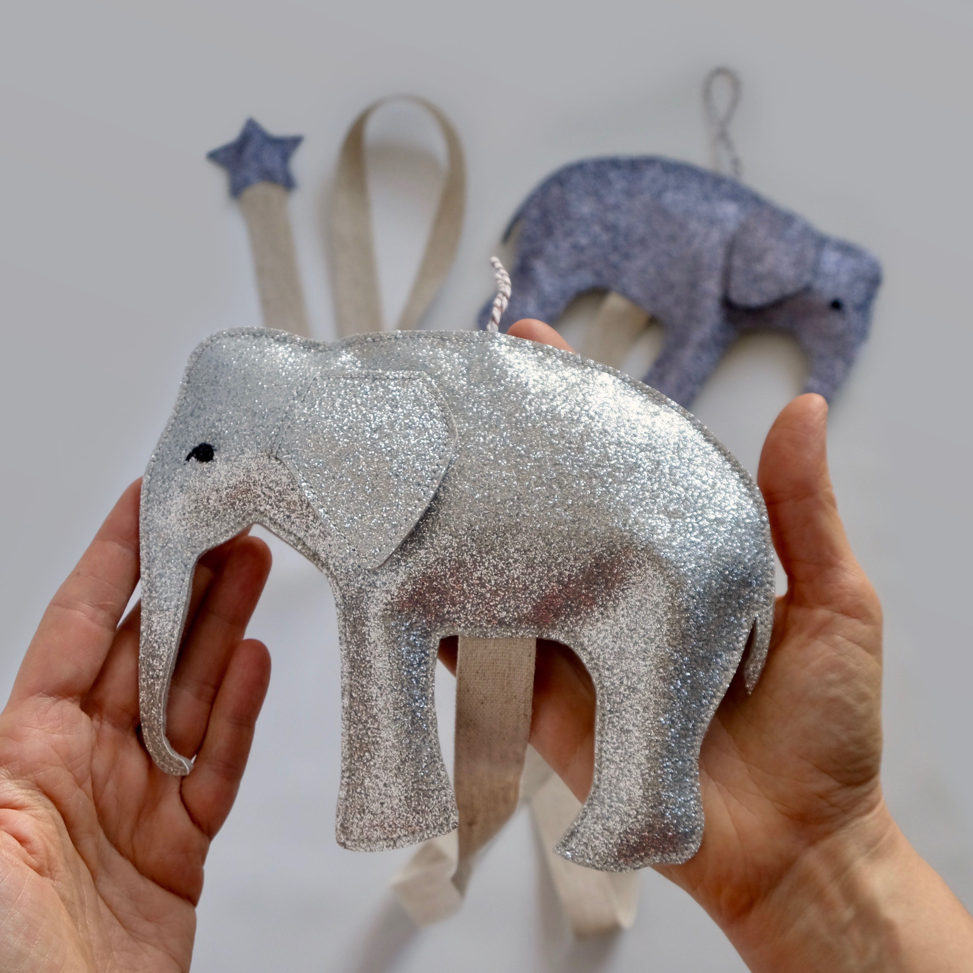 Silver elephant hair accessories organizer, a functional wall decoration for a nursery or children's room.