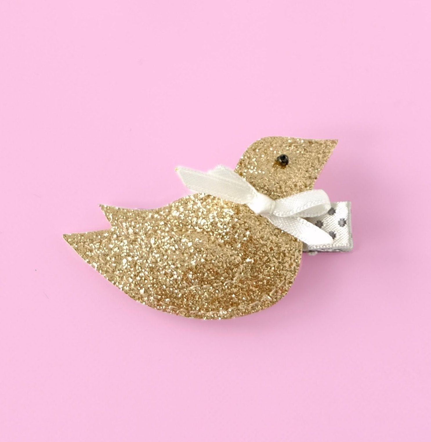 Unique and stylish, this whimsical bird with a bow hair clip is the perfect accessory for any Spring event.