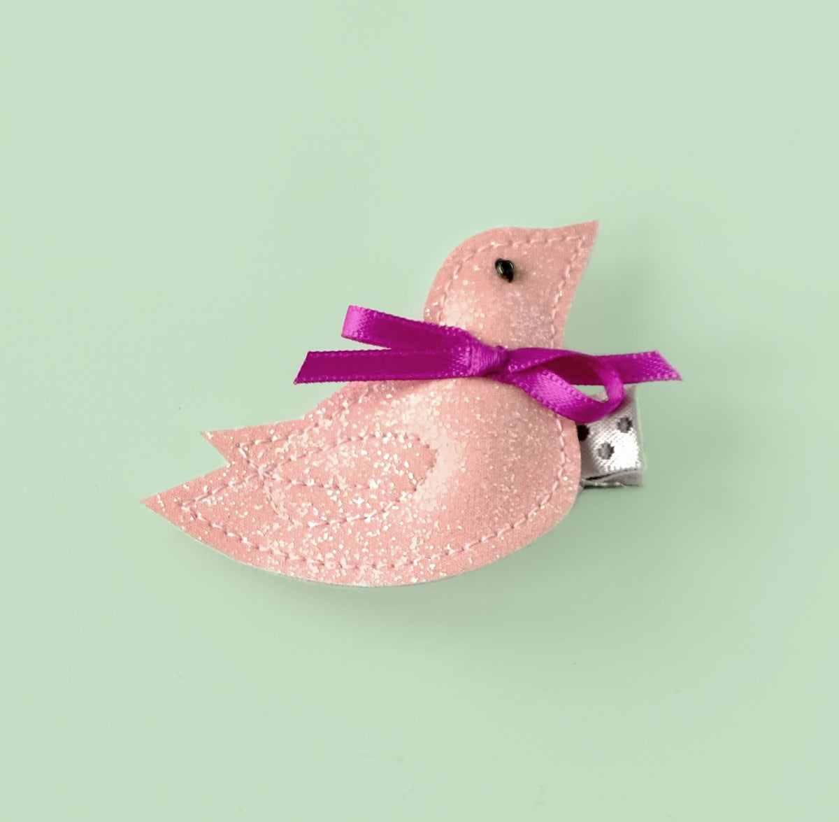 Adorable in baby pink, this little bird with a fuchsia bow will add a special touch to your girl's outfit.