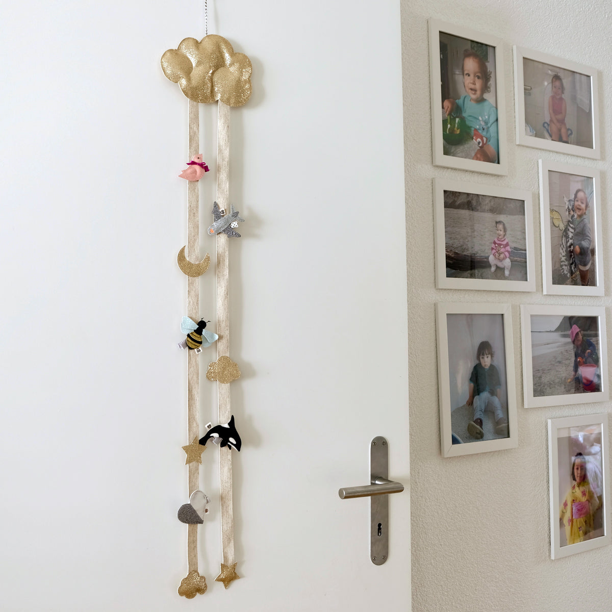 Room with cloud shaped hair clip organizer hanging on the door.