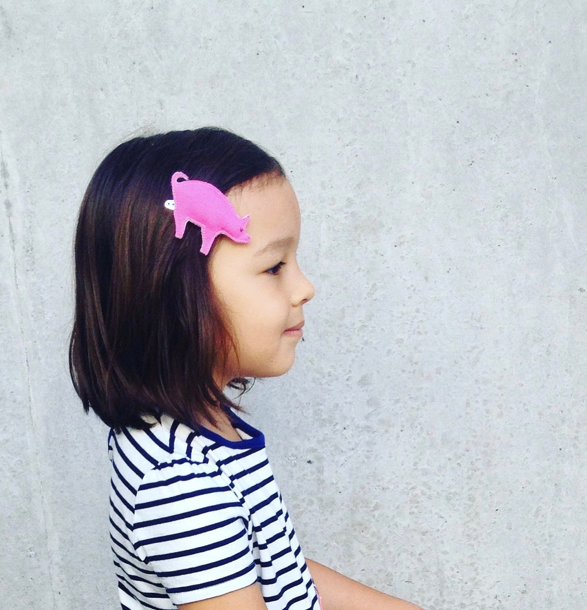 Image of a toddler wearing our sweet piggy hair clip.