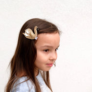 Your little girl will turn heads with this striking gold swan hair clip.
