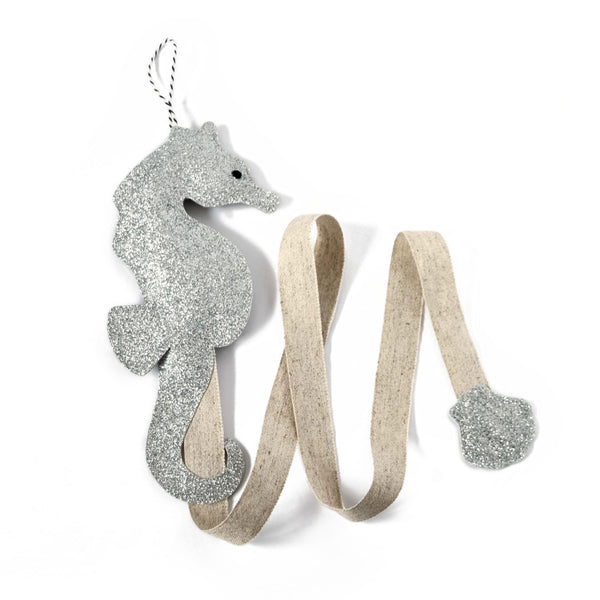 A silver seahorse shaped hair clip holder that is both stylish and functional.