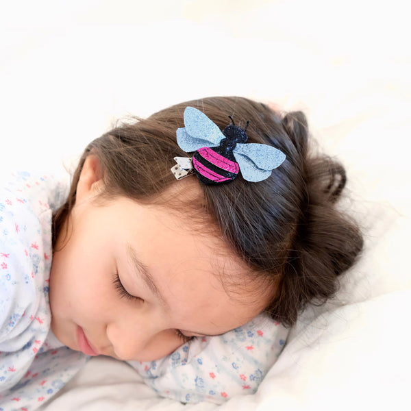 Sleeping girl with bee clip.
